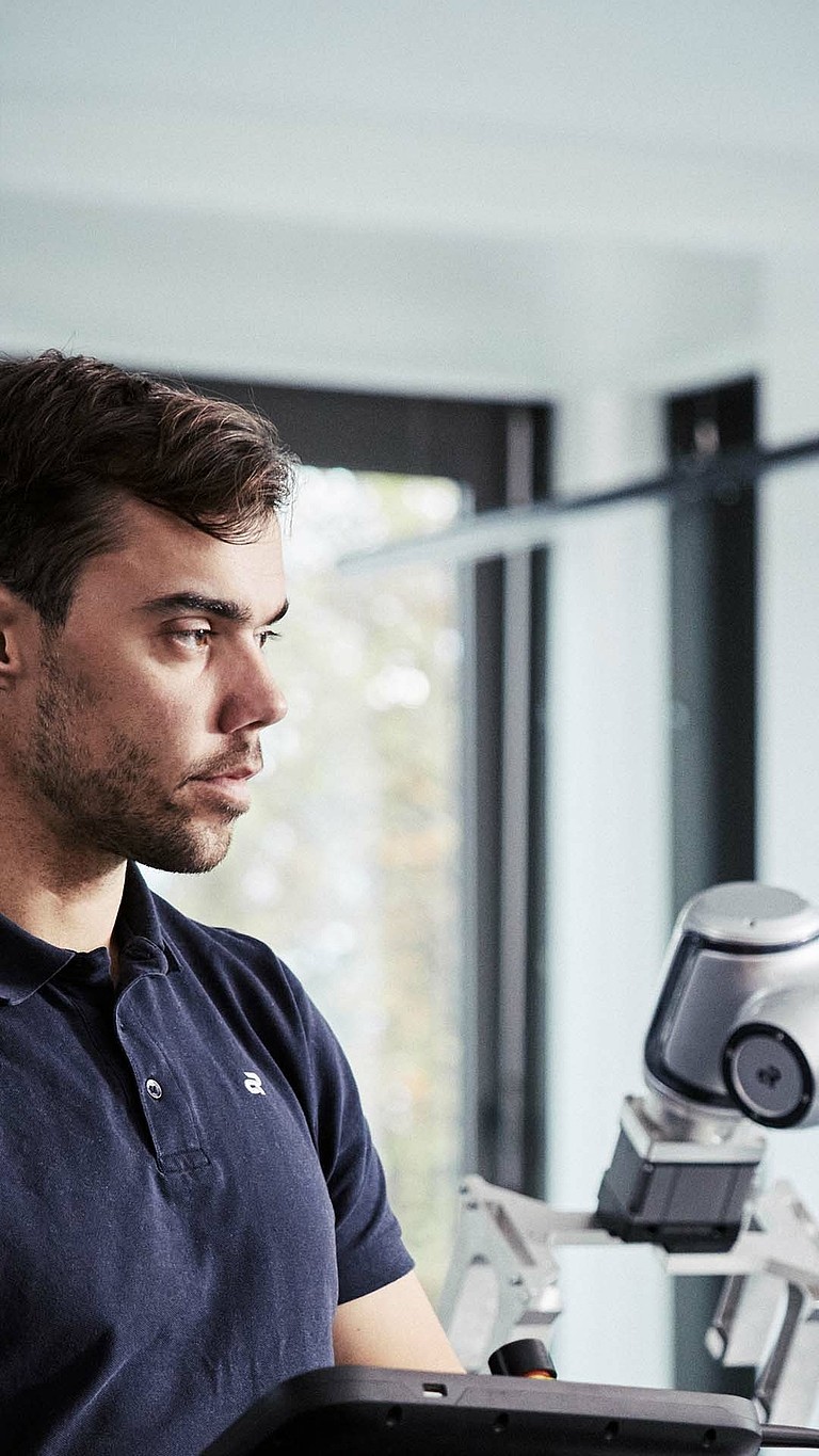 An Agile Robots employee programming the seven-axis robot Diana 7