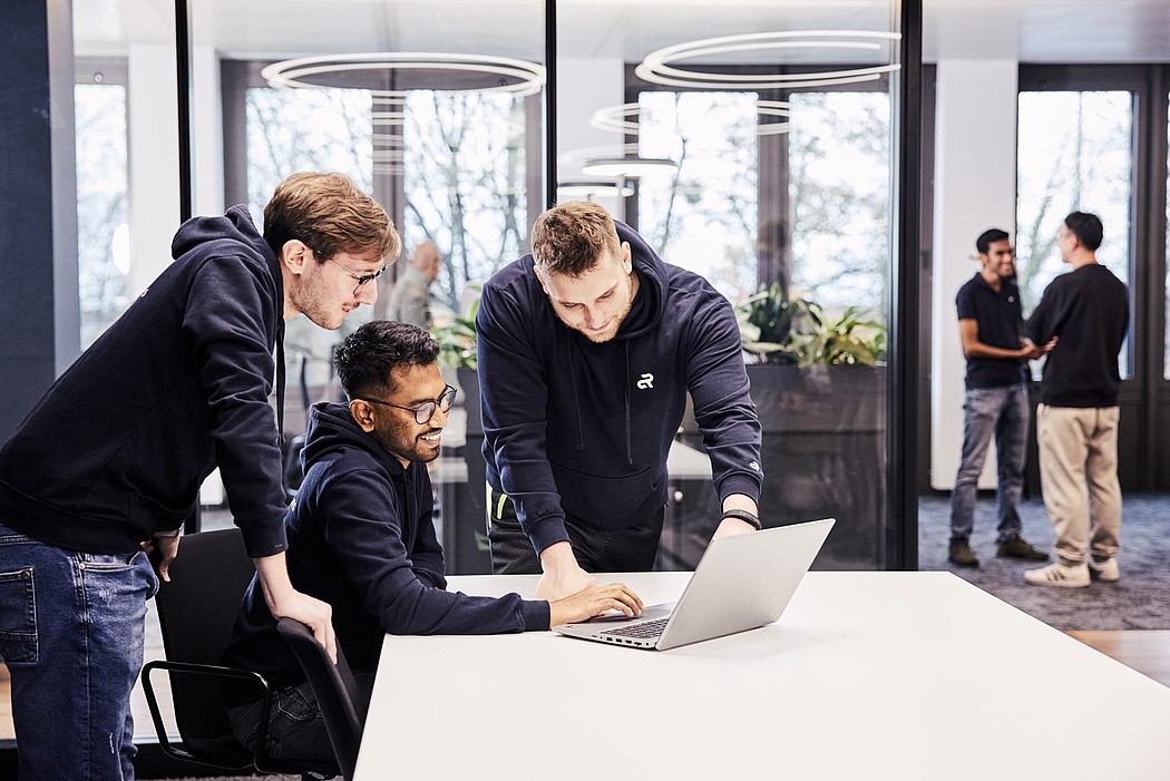 Multiple Agile Robots employees in a team meeting